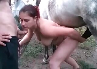 Red-haired chick shines in a zoophile orgy here